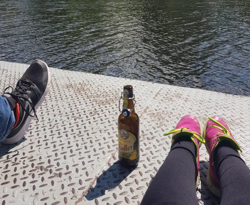 Picture of a bottle of a Radler beer and shoes